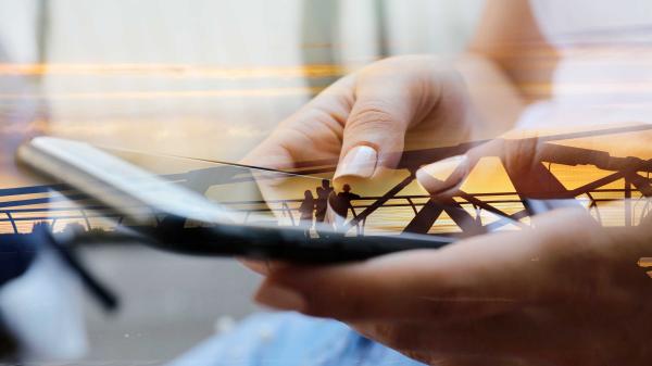 Woman working on large mobile phone.