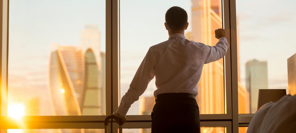 Business man looking out office window