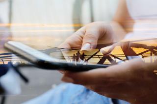 Woman working on large mobile phone.