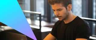 Male IT professional working on a laptop.