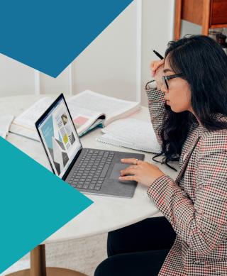 Female IT professional working on a laptop.