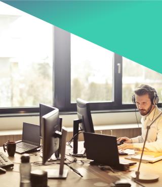 Professional male working at a computer desk.