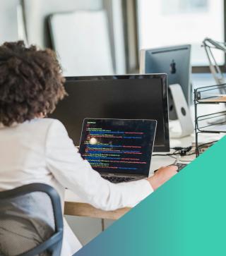 Woman working at laptop on an office desk