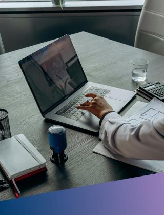 A senior recruitment consultant reviewing project roadmaps and digital requirements on a laptop, representing the initial consultative briefing phase where Deerfoot aligns talent search with government service standards.