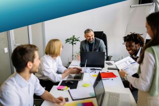 A multidisciplinary agile team in a collaborative workshop, representing the GDS-aligned Delivery Managers, Designers, and Product Owners Deerfoot sources for large-scale government digital programmes