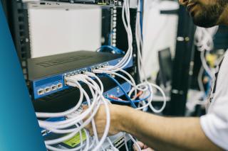 Server Engineer Fixing Cables on Server