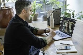 IT professional at a home desk on a video call with a recruiter