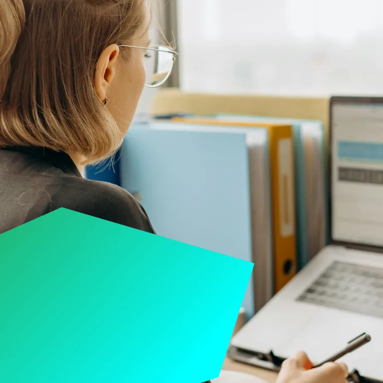 Professional female working on a laptop at a desk.