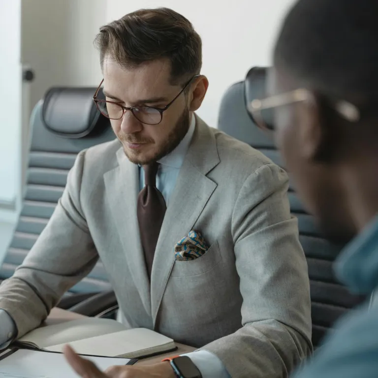 A specialist technology recruiter meticulously reviewing candidate documentation to verify technical experience and professional credentials.